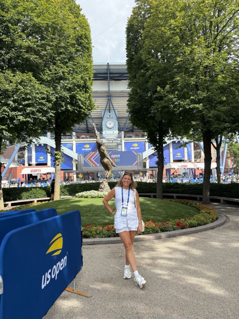 Woman standing in front of stadium