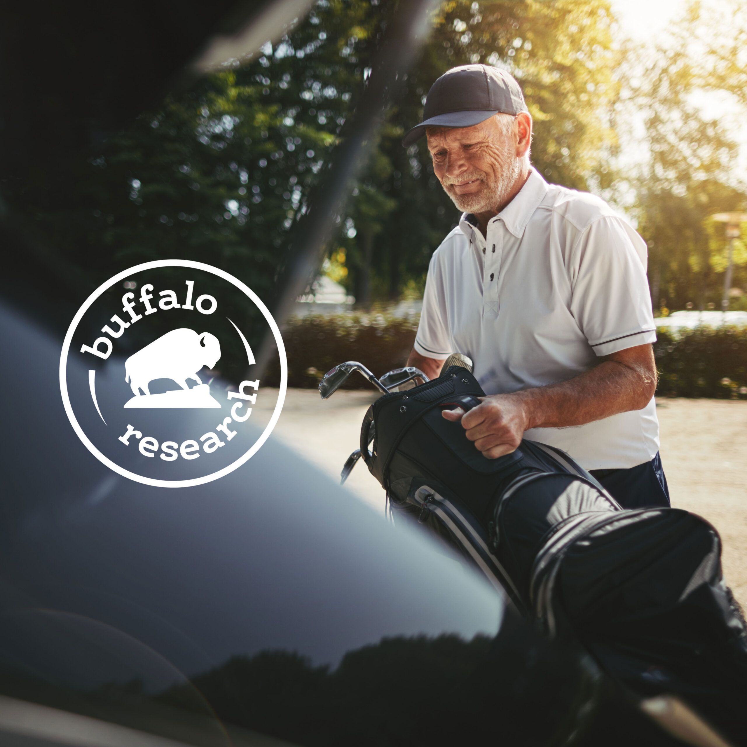 Older golfer loading a golf bag into a cart with a Buffalo Research logo overlay on the image.
